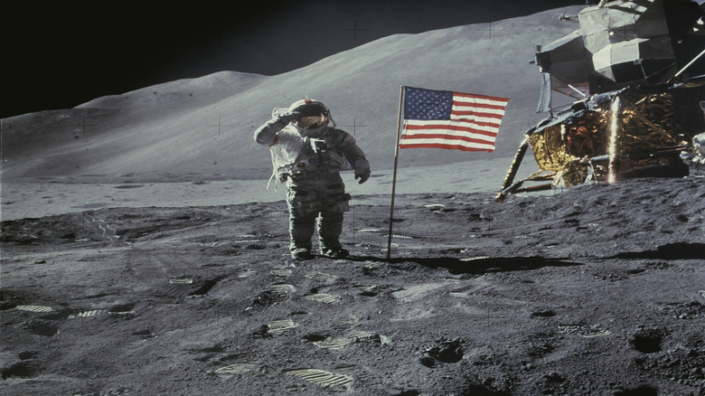 American astronaut David R Scott salutes the American flag during the Apollo 15 lunar mission in 1971.