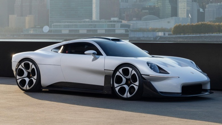 Porsche Mission S parked next to water with city skyline in the background