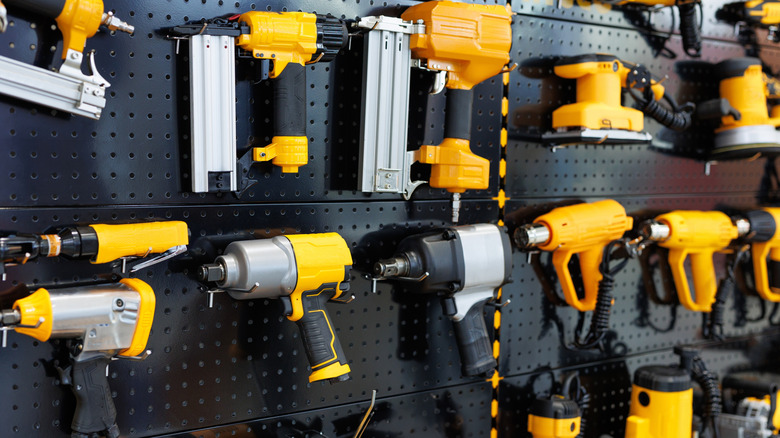 A series of yellow power tools are prominently displayed.