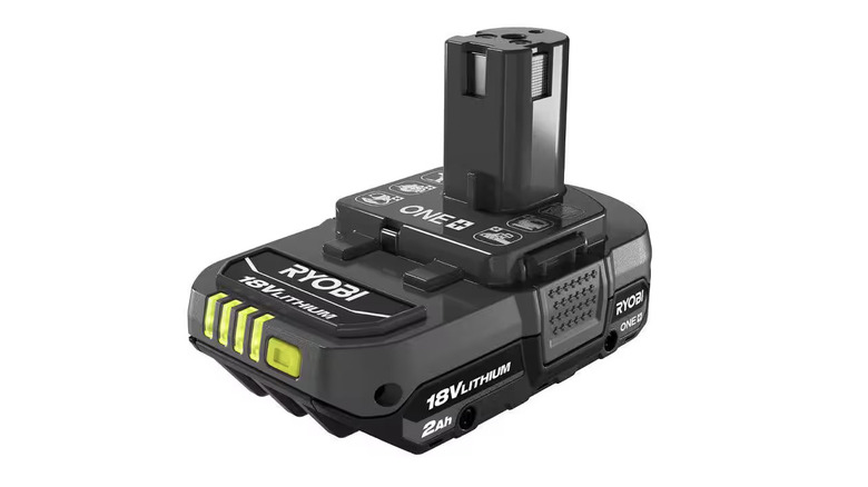 A person uses a Ryobi drill with a 18V 2Ah battery