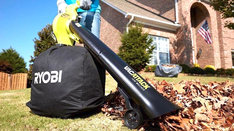 Person using Ryobi vacuum/mucher in front yard