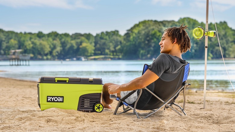 Ryobi cooler on beach with man