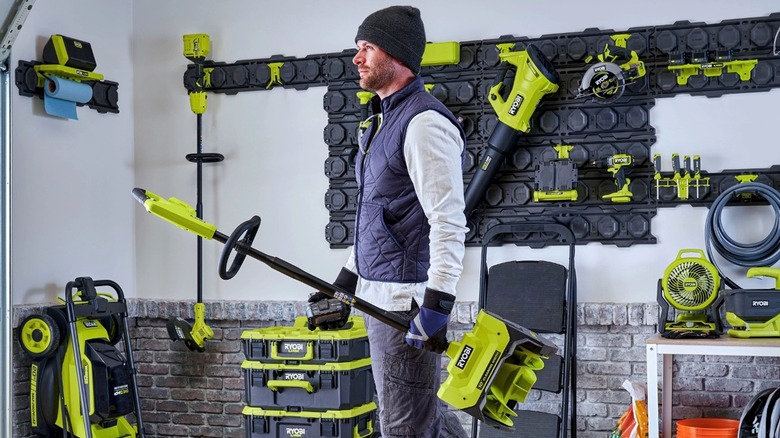 Man carrying electric snow shovel