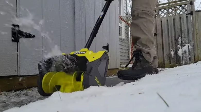 Person using electric snow shovel