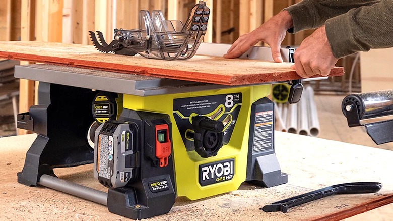 Person using Ryobi Table Saw