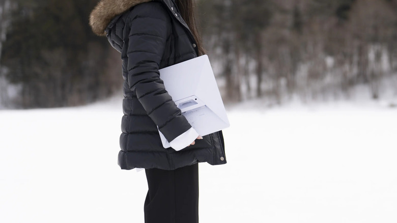 A person carrying a Starlink Mini