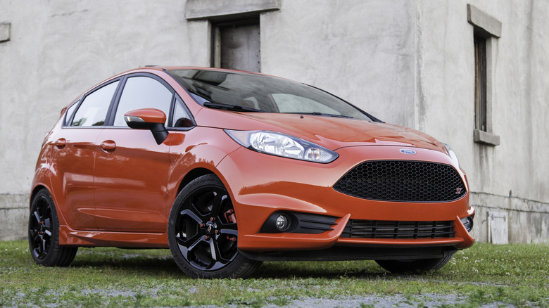 A red 2016 Ford Fiesta ST in front of a building