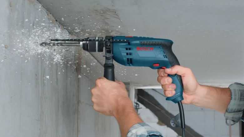 Person using a Bosch hammer drill