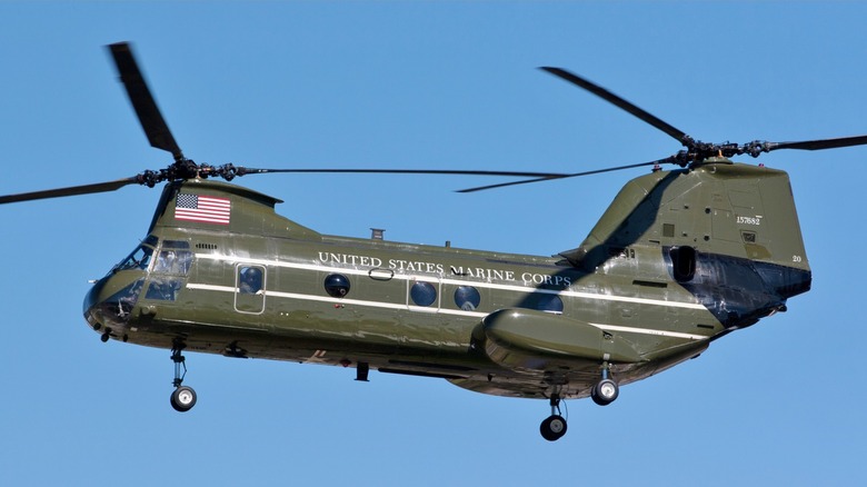 A U.S. Marine Corps CH-46 flying against a blue cloudless sky