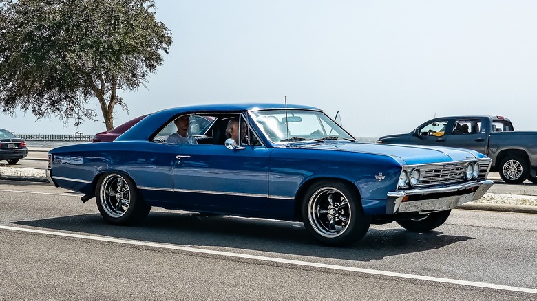 Blue Chevy Chevelle Malibu driving down the street