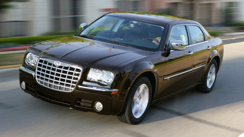 A black 2010 Chrysler 300 on the move, front 3/4 view
