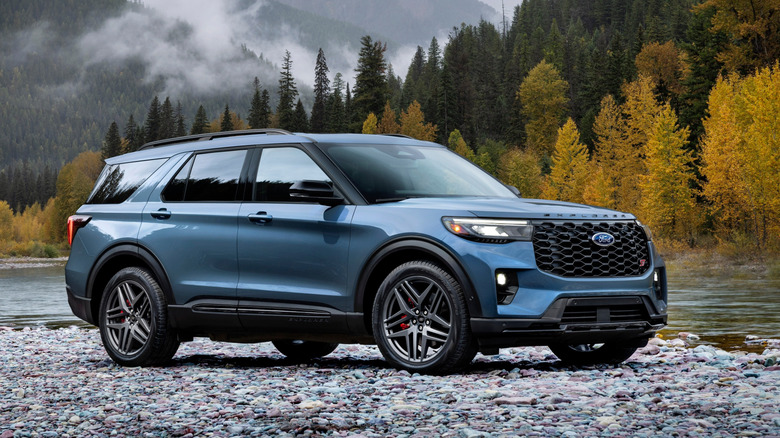 Front 3/4 view of blue Ford Explorer ST parked near lake.