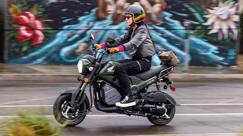 Person riding Honda Navi on street