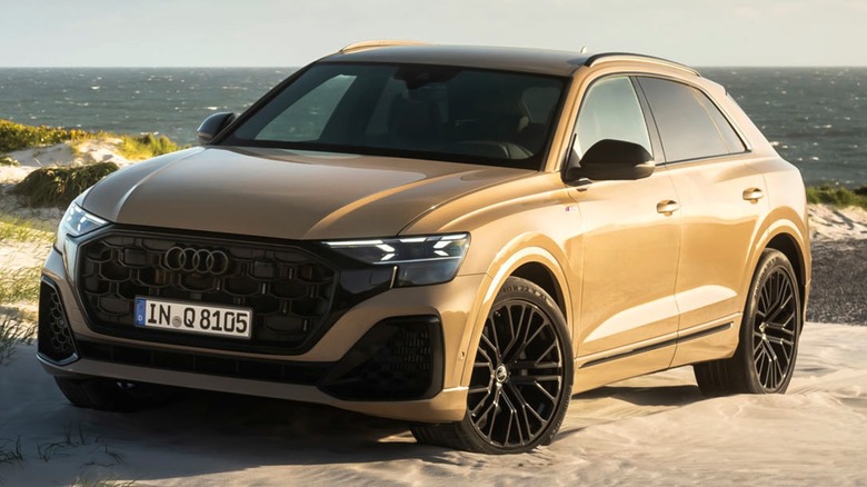 an Audi Q8 on a beach