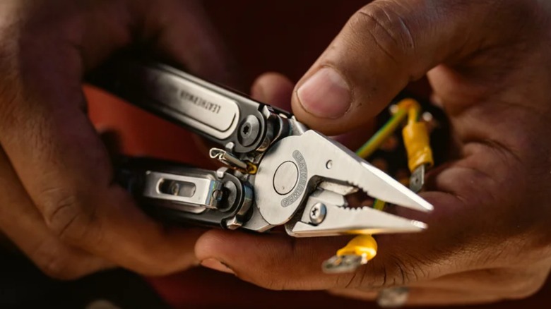 Close up of a person holding a Leatherman Arc