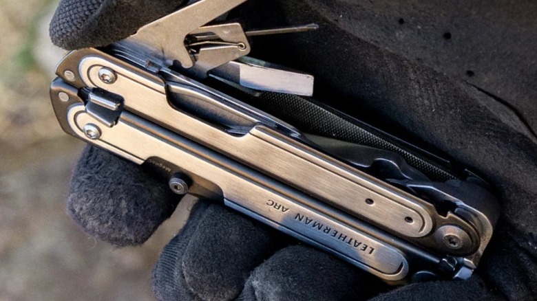 Close up of Leatherman Arc in a person's gloved hand