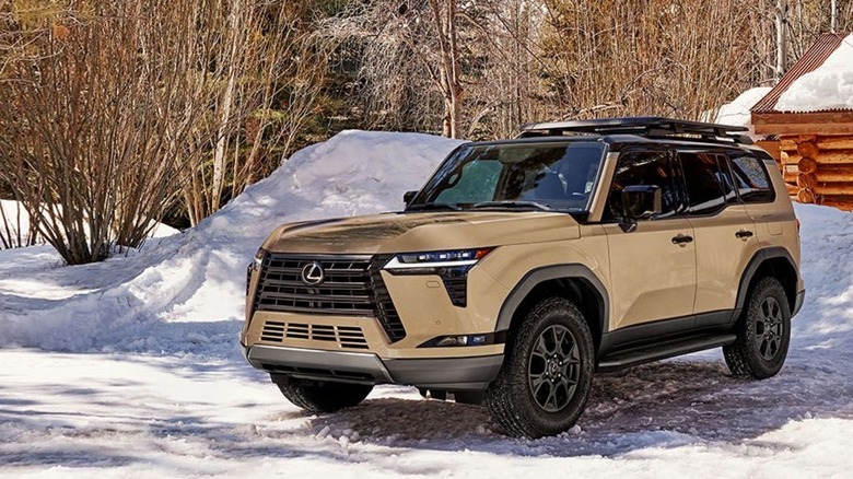 A brown Lexus GX parked in the snow