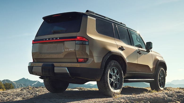Rear quarter view of a 2025 Lexus GX parked on a mountain trail