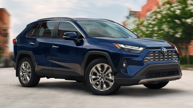 blue 2025 Toyota RAV4 parked on city street