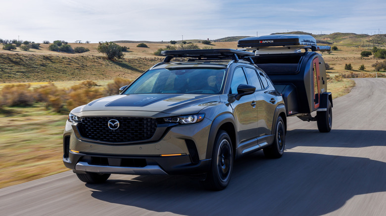 Mazda CX-50 towing a trailer on the road