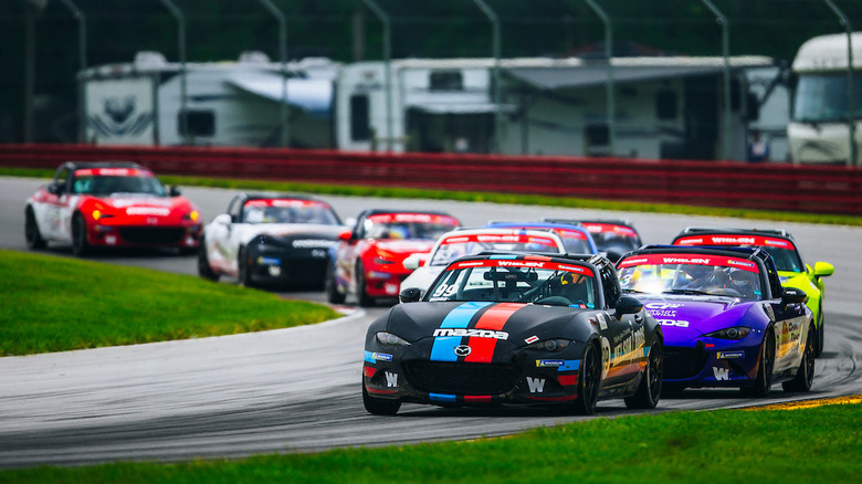 Mazda MX-5 Cup race cars on road course