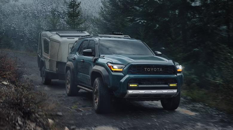 2025 Toyota 4Runner Trailhunter in Everest paint towing a small trailer up a hill
