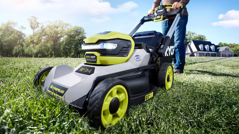 person pushing ryobi lawn mower