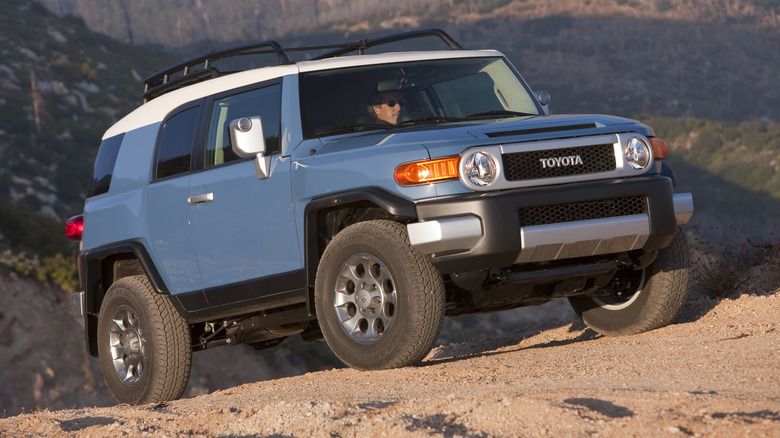 Blue Toyota FJ Cruiser on mountain trail