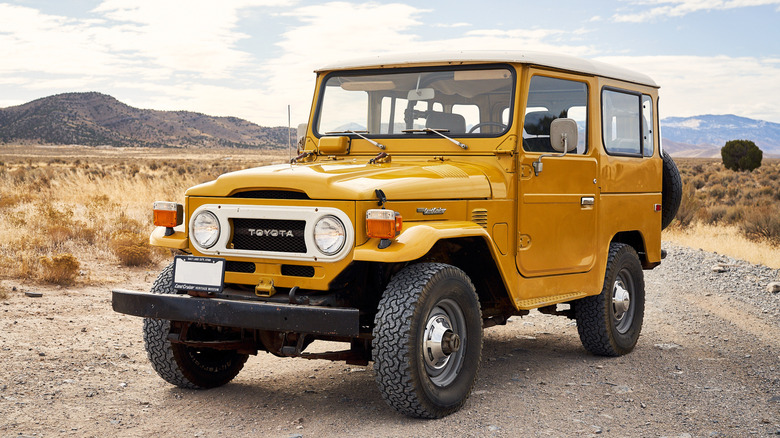 Yellow FJ40 Toyota Land Cruiser on desert trail