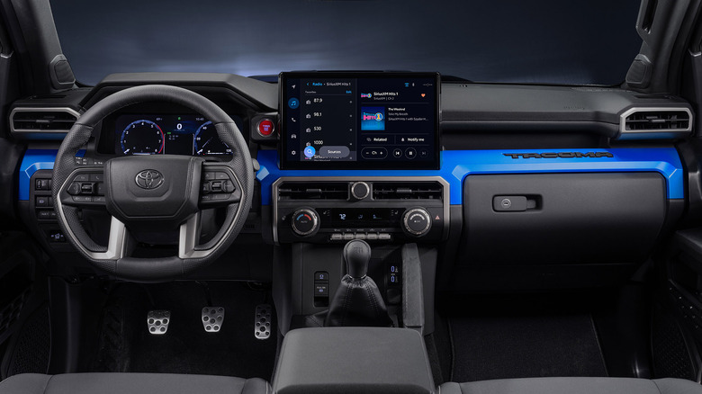 View of blue Toyota Tacoma interior with manual transmission.
