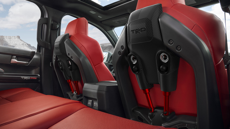 Red upholstered interior of Toyota Tacoma TRD Pro showing IsoDynamic shock absorbers on back of passenger and driver seats
