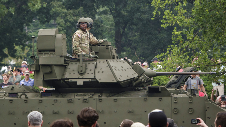 U.S. soldiers at parade in a Bradley Fighting Vehicle -- a vehicle slated to be replaced by the hybrid-powered XM-30.
