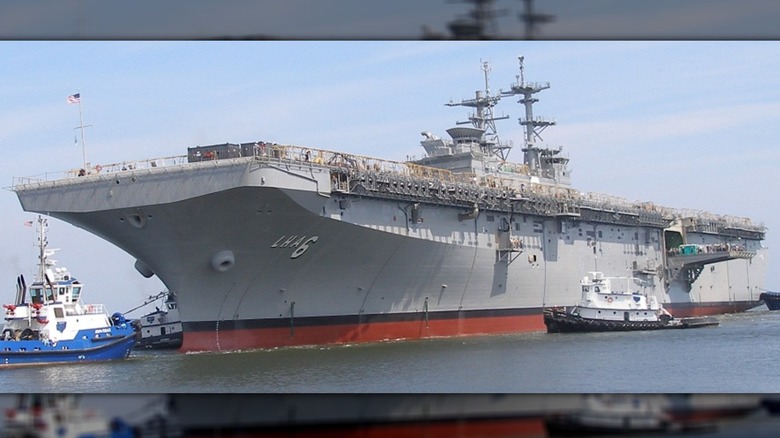 The USS America (LHA-6) being tugged