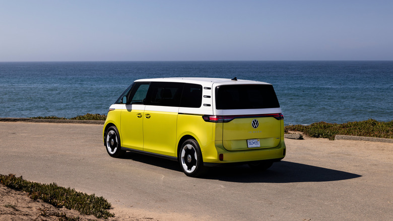 The Volkswagen ID. Buzz in white over yellow, coastline, rear 3/4 view