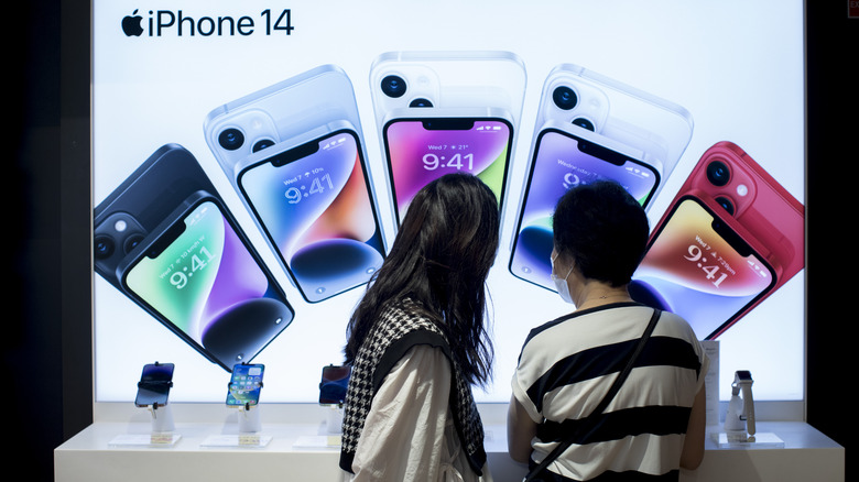 Apple Store shoppers browse iPhones
