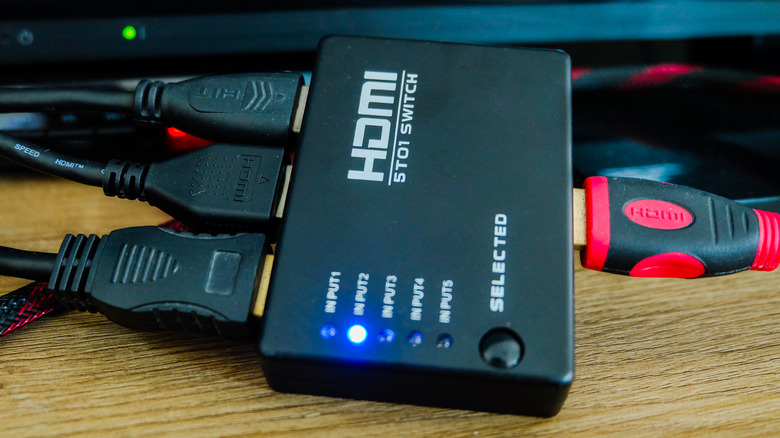An black HDMI switch box with multiple input ports and leads