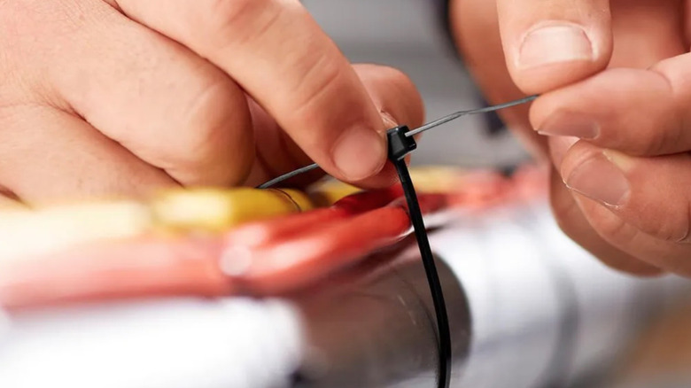 Person using black Harbor Freight zip tie