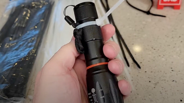 Person using white Harbor Freight zip tie