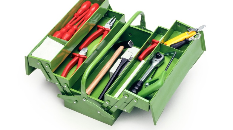 Green tool box with tools in it