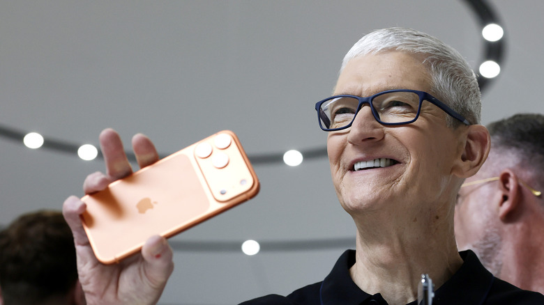 Tim Cook holding an iPhone.