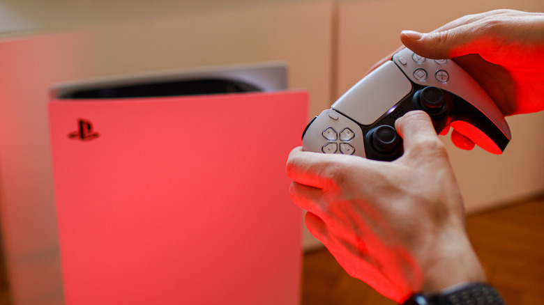 PS5 on floor controller hands