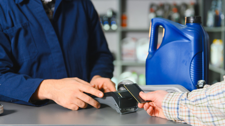 paying money at a car repair shop