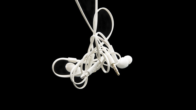 Tangled wired white earbud headphones