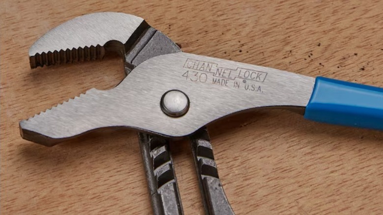 Channellock tongue and groove pliers on a wood surface