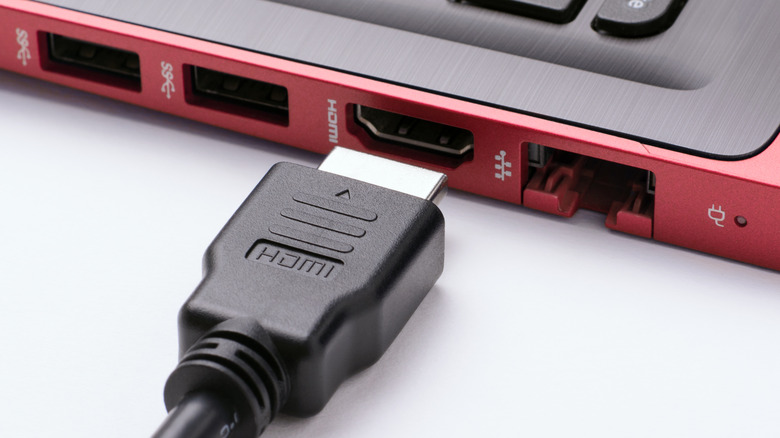 HDMI cord being plugged into a laptop