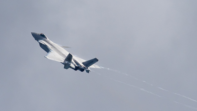 Chengdu J-20 doing acrobatics against the clouds