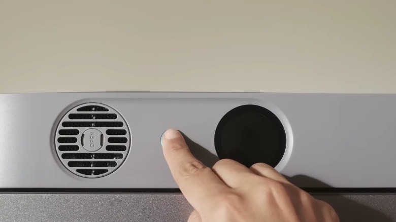 Close-up of a button being pushed on a Jackery FridgeGuard.