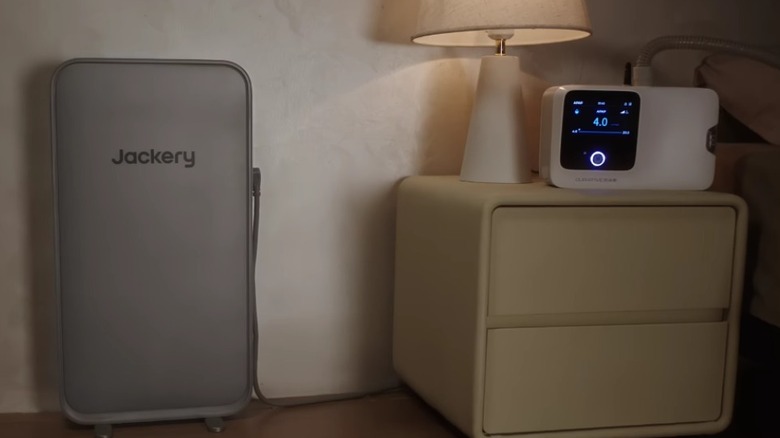 A Jackery FridgeGuard unit powering a bedside device.