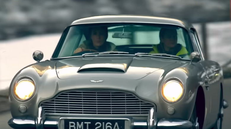 Contestants driving an Aston Martin DB5
