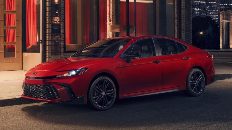Front left view of red toyota camry parked on city street